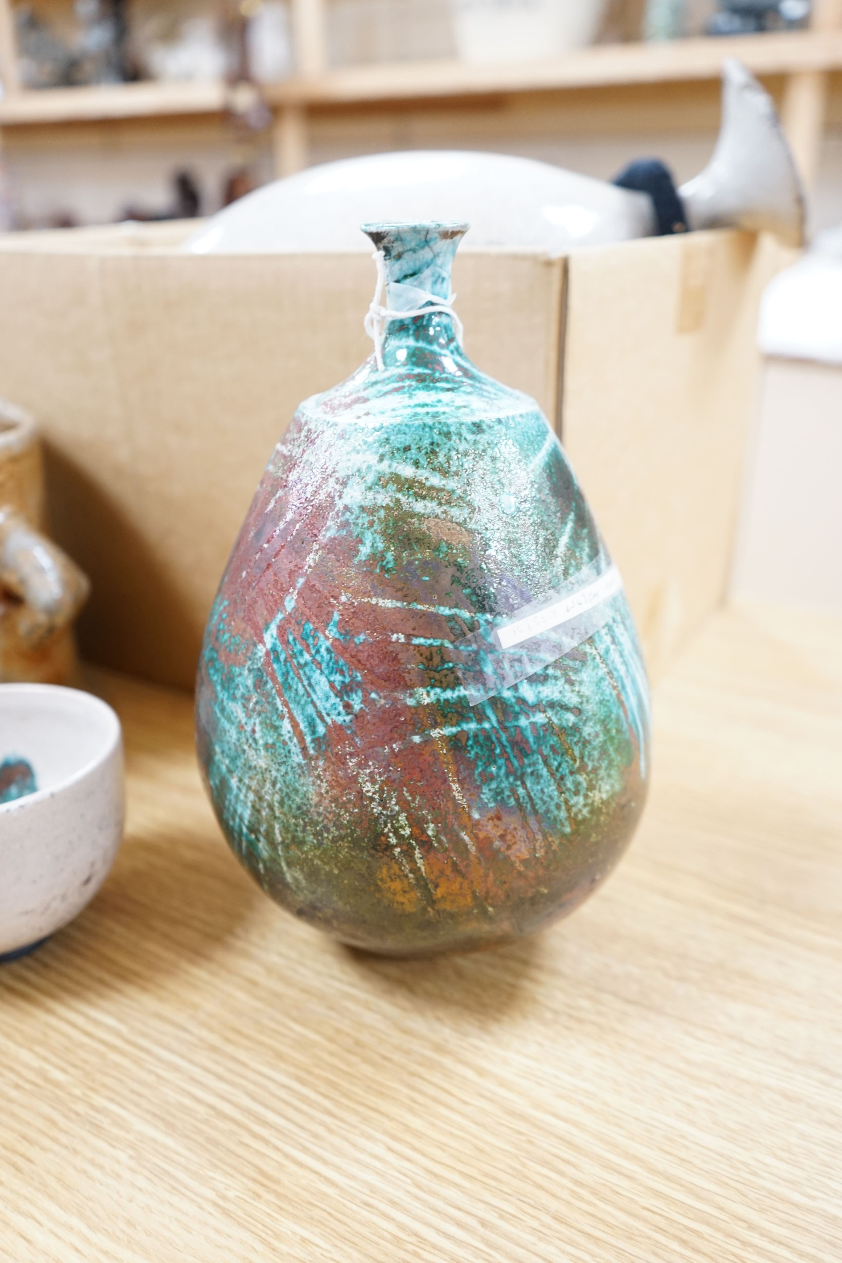 Studio pottery- an Allison Weightman raku fired large albastron form vase, ovoid vase and cup and a Petra Reynolds oval stoneware pot (4) Tallest 44cm
